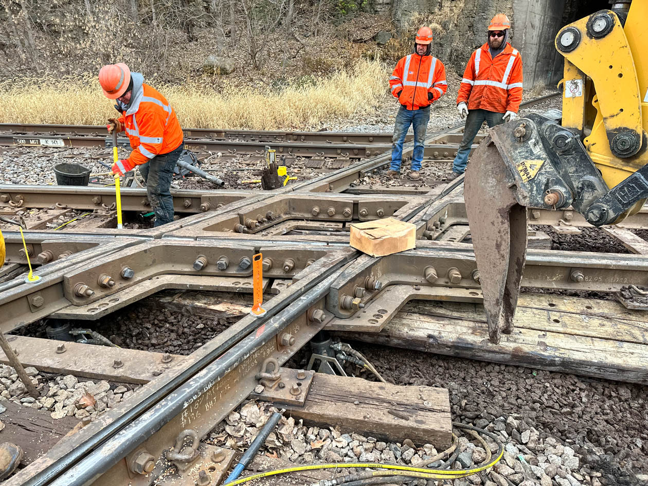 Lifting and holding the railroad diamond while crews change the wooden timbers under the diamond